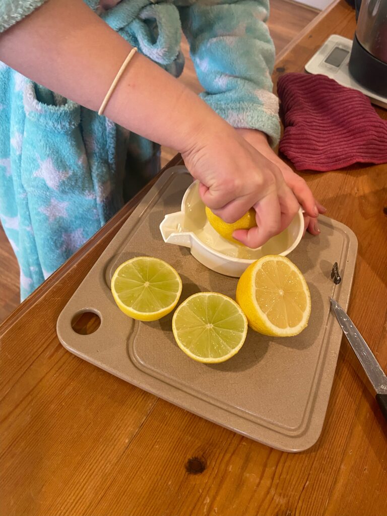Child squeezing lemon juice using a juicer